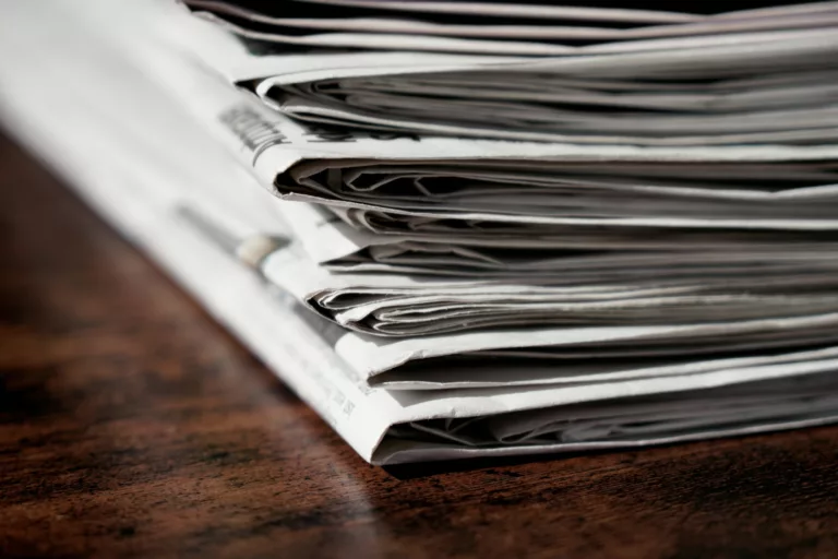 newspaper stack on table